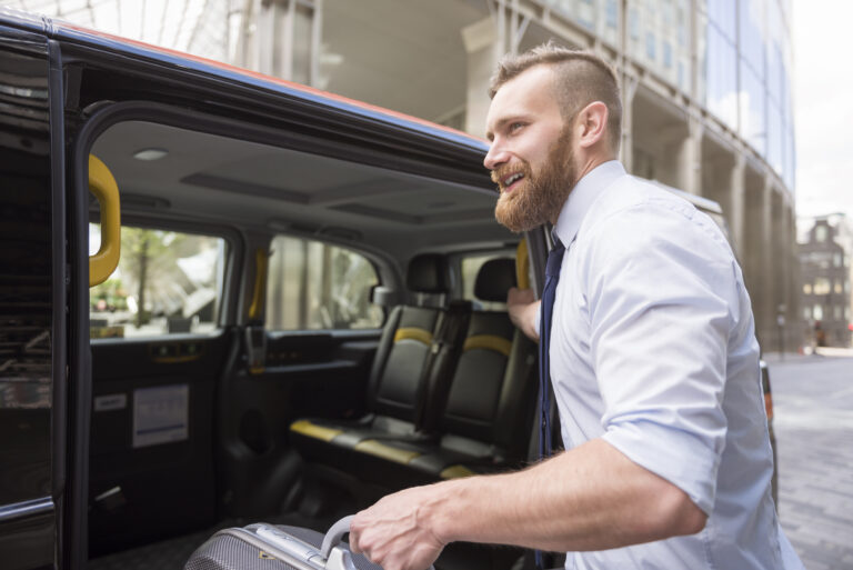 Corporate traveler entering a shuttle van for business transportation.
